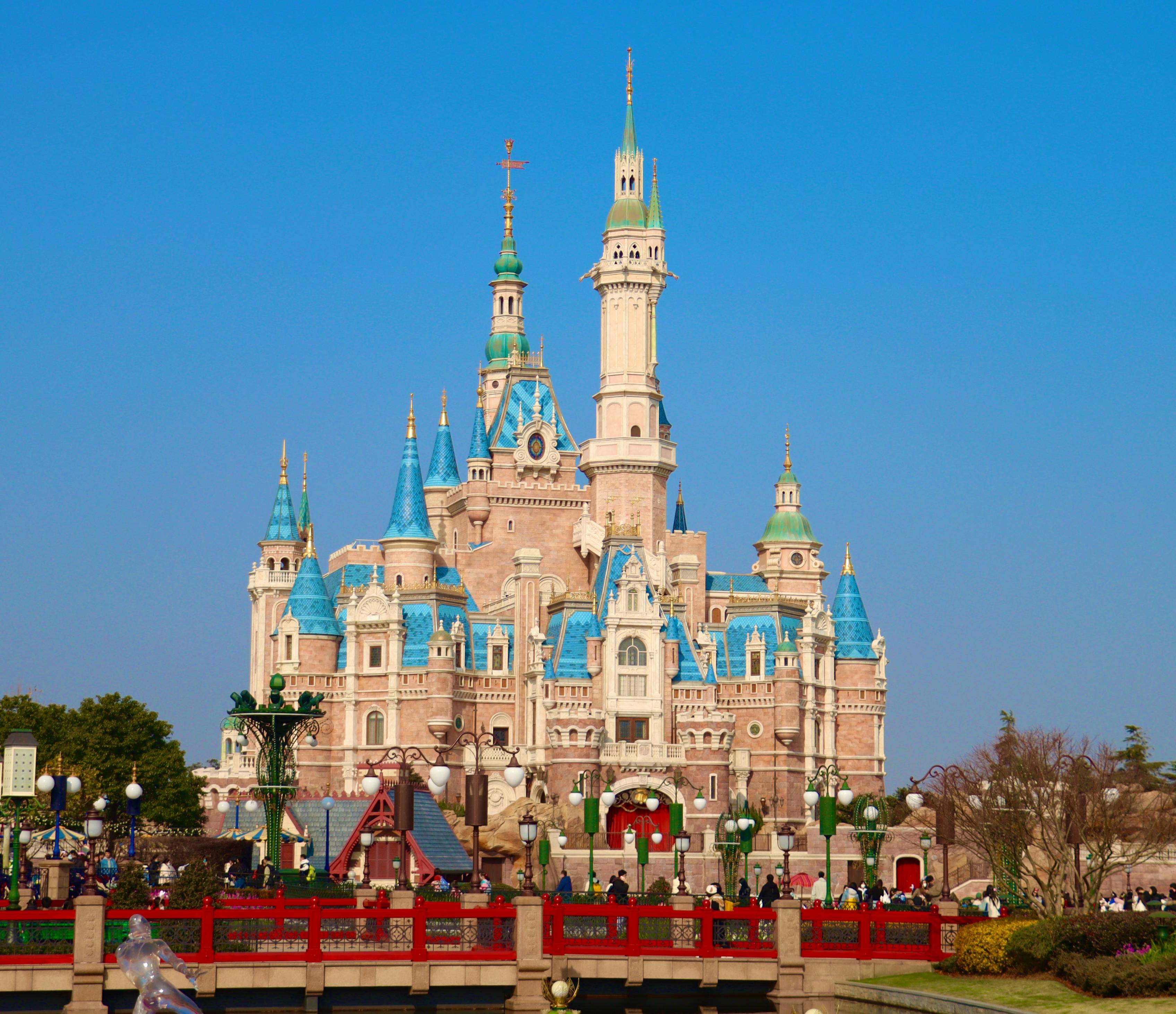 a castle with a red bridge in front of it