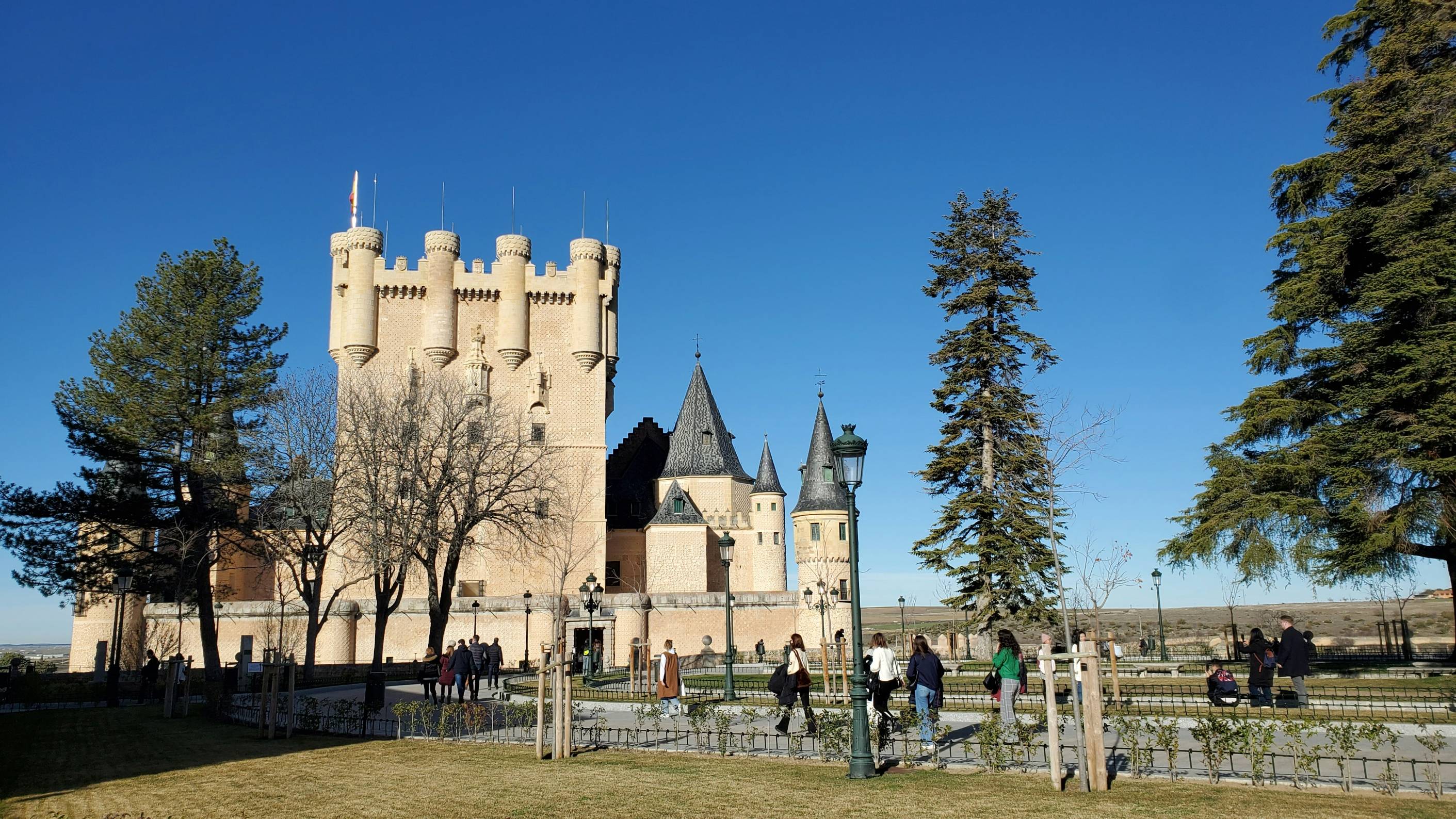 a castle with people walking around in front of it