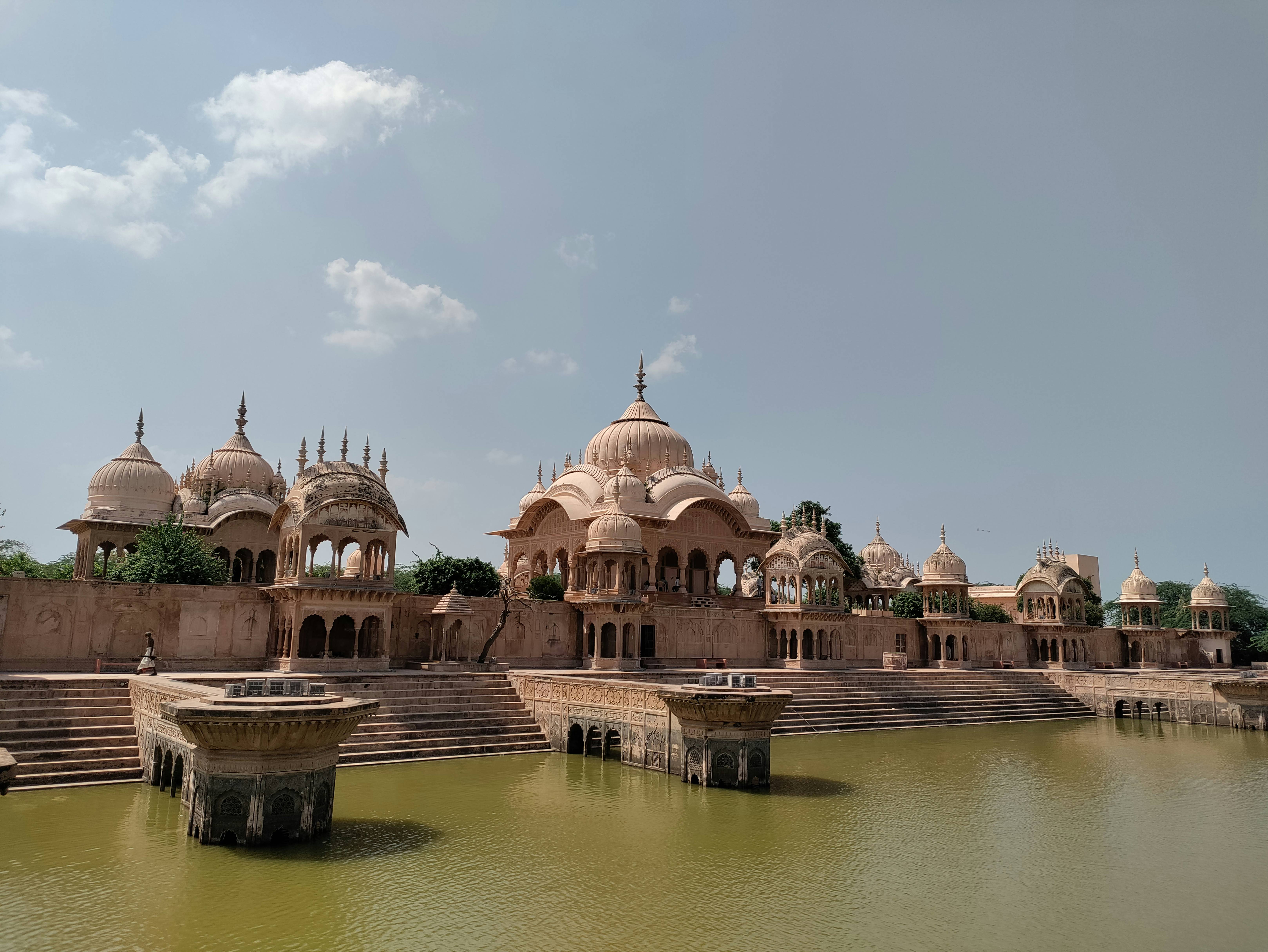 a body of water with a building in the background