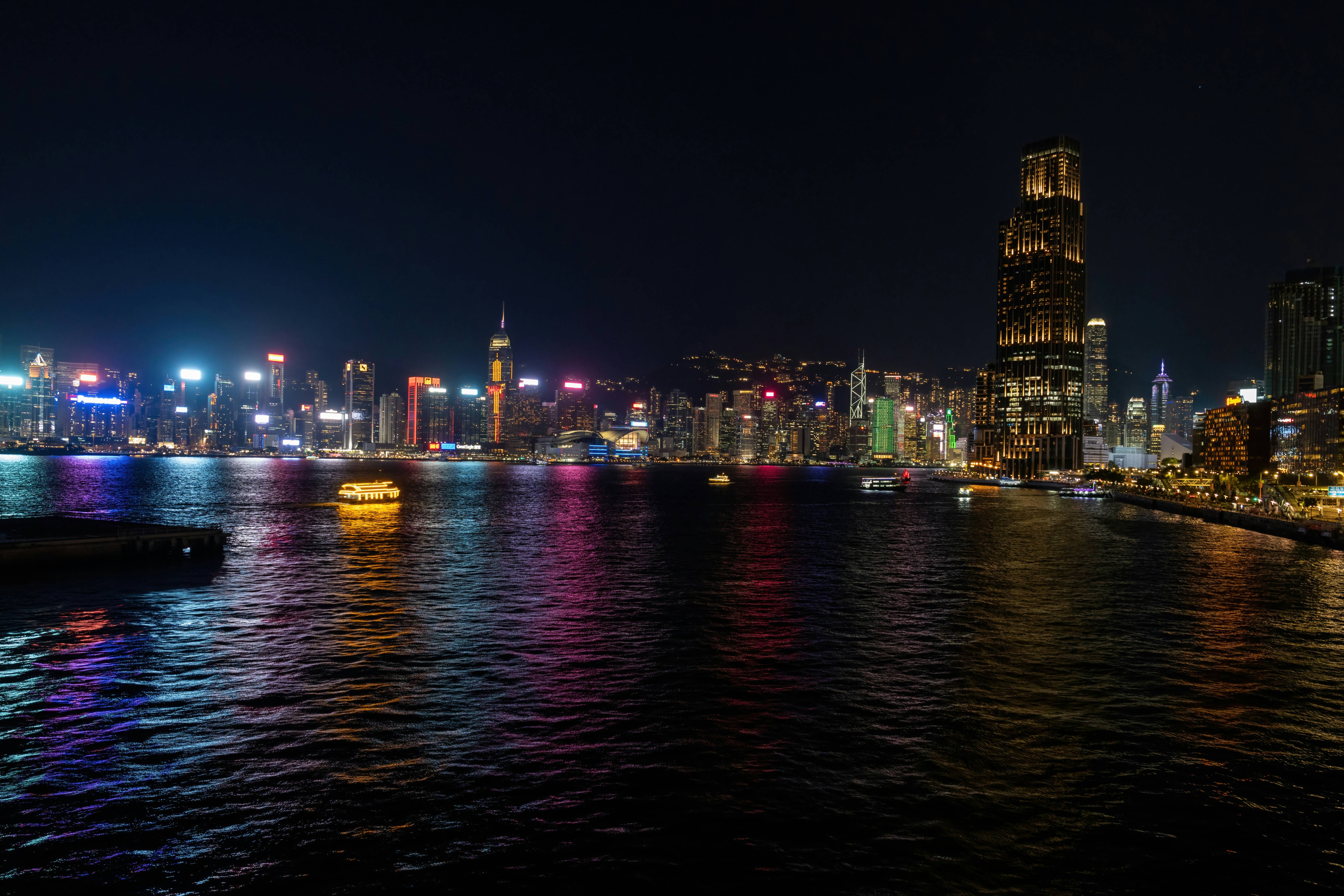 a large body of water with a city in the background